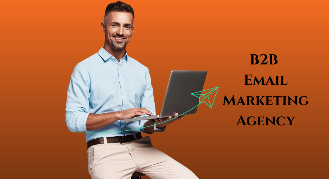 A professional man holding a laptop, representing a B2B email marketing agency.