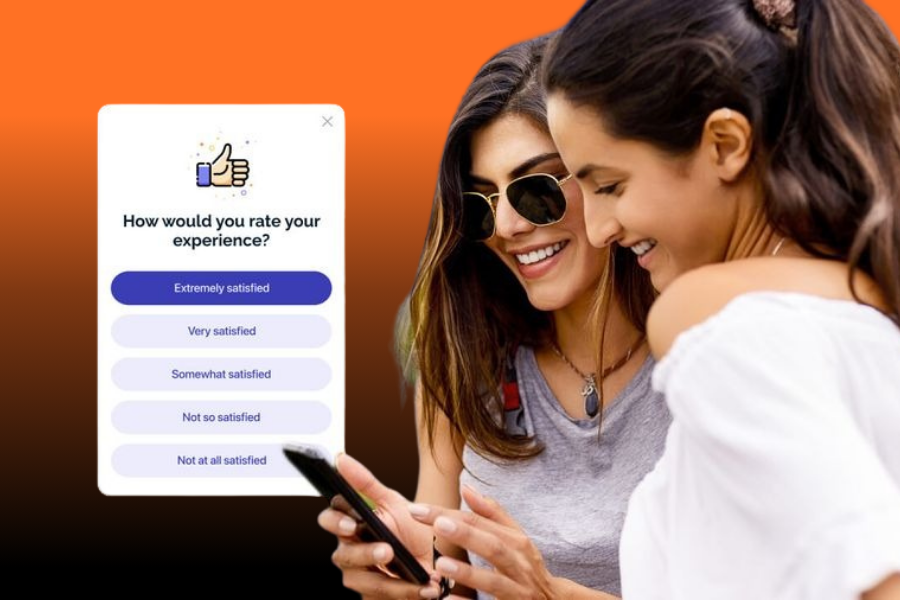 Two young women smiling while interacting with a user survey designed by an Android App Development UK agency.